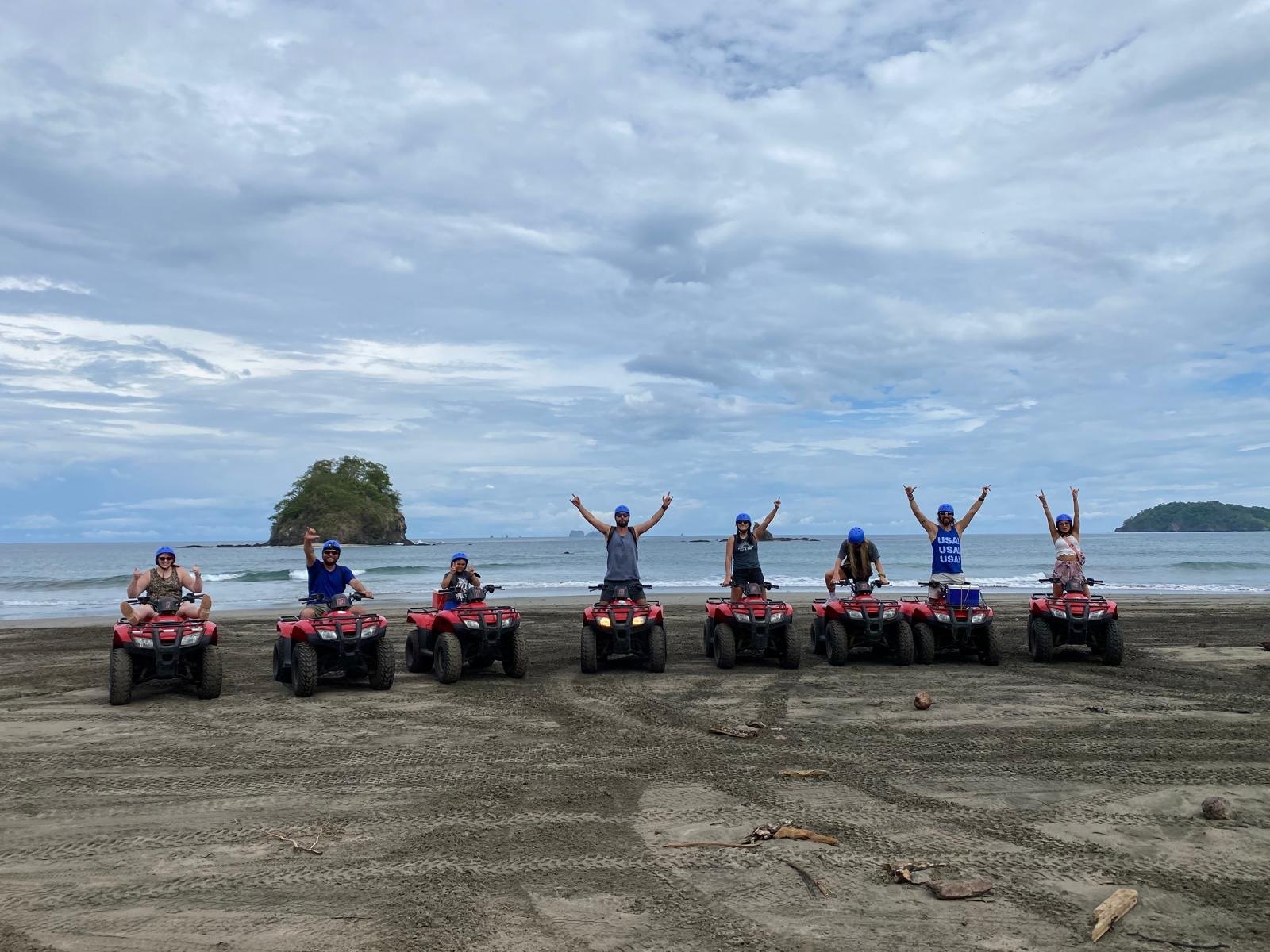 Guests on ATVs beside the beach