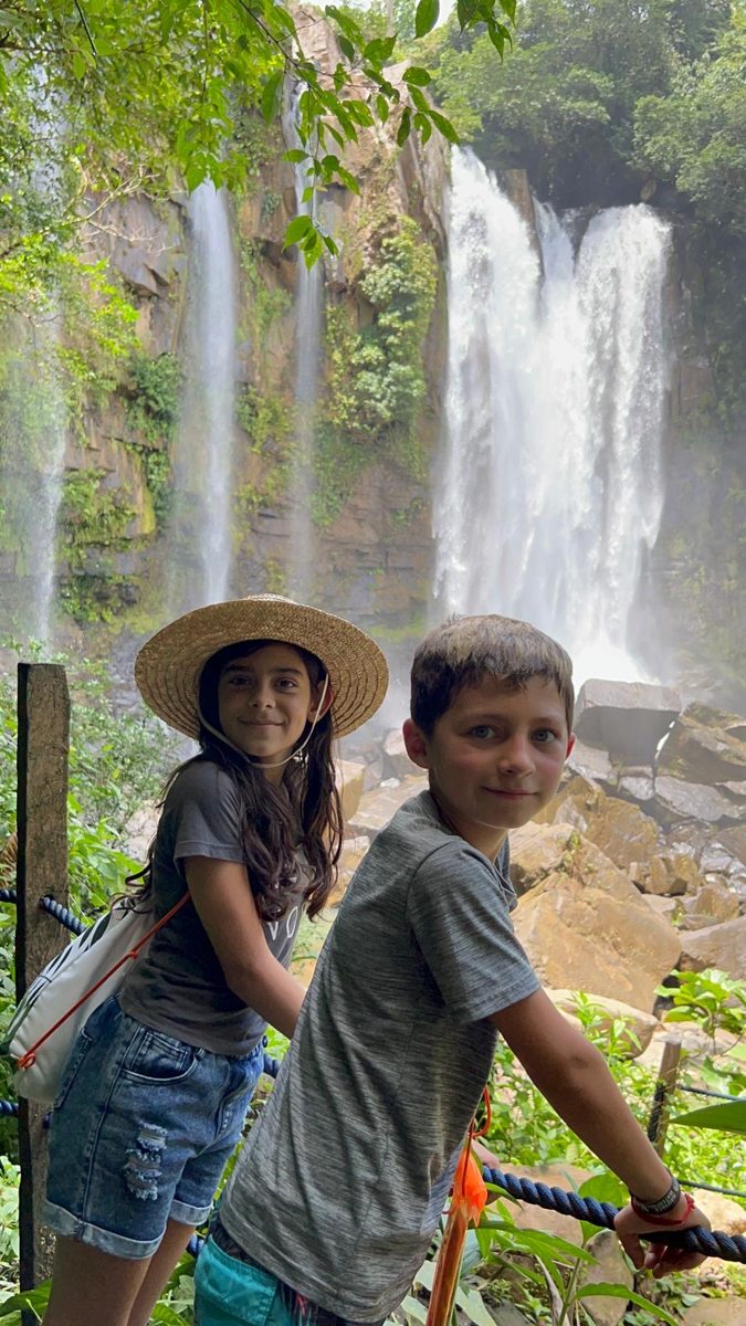 Two children exploring a waterfall