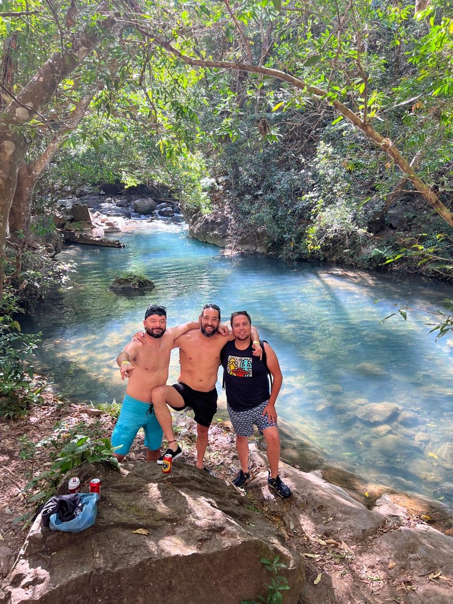 Two guests together beside a forest river