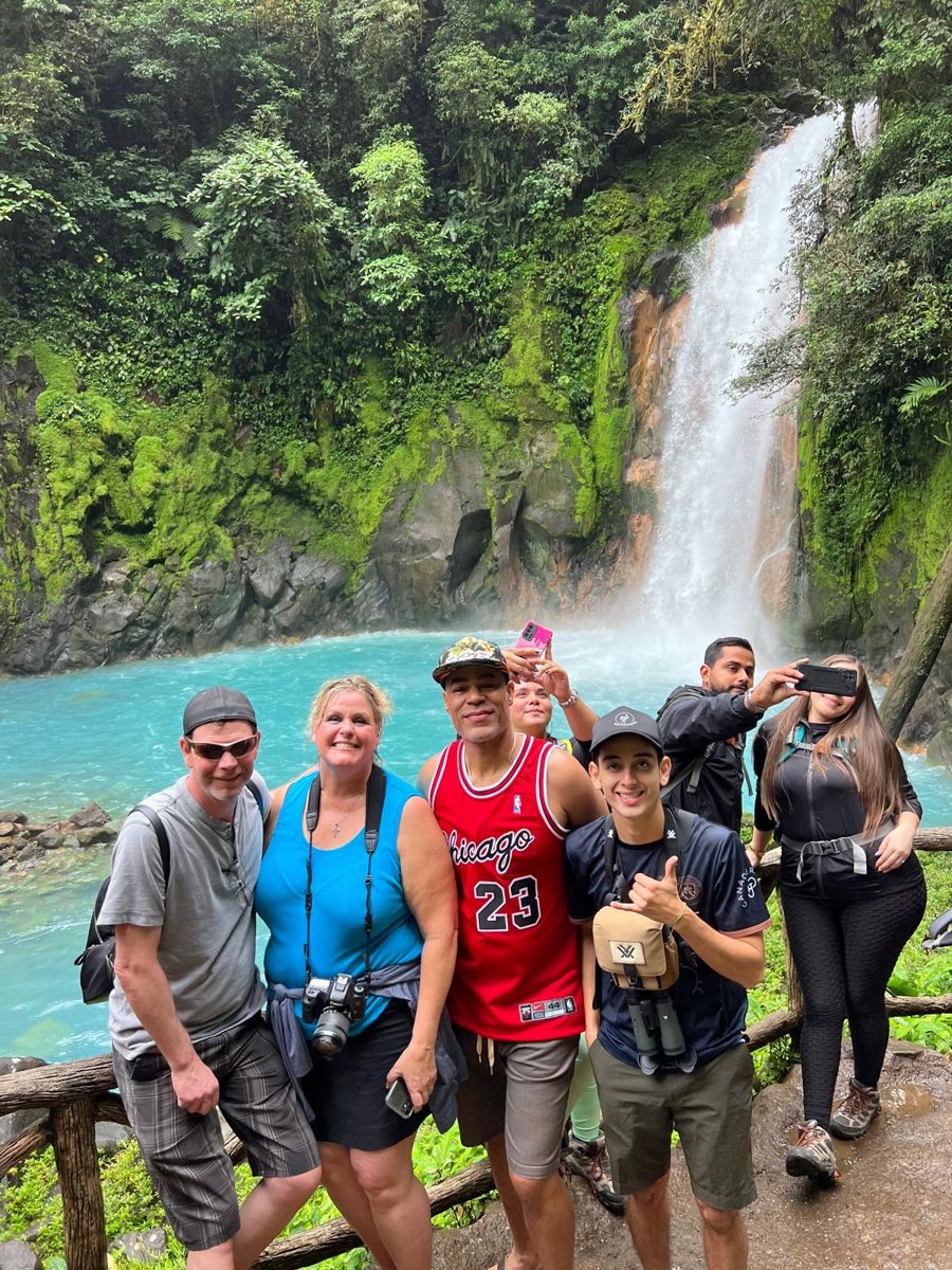 Friends together at a turquoise waterfall
