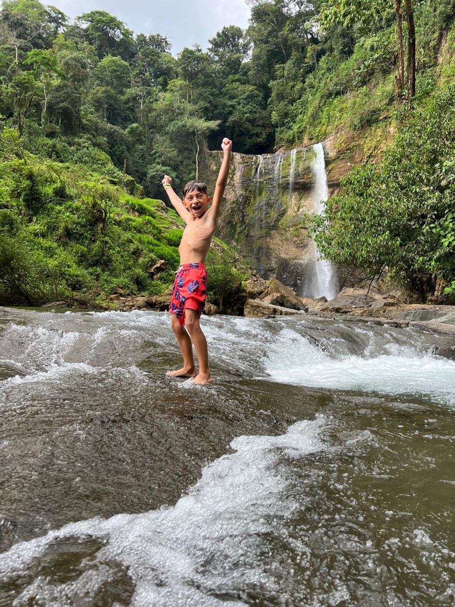 A guest enjoying a waterfall river