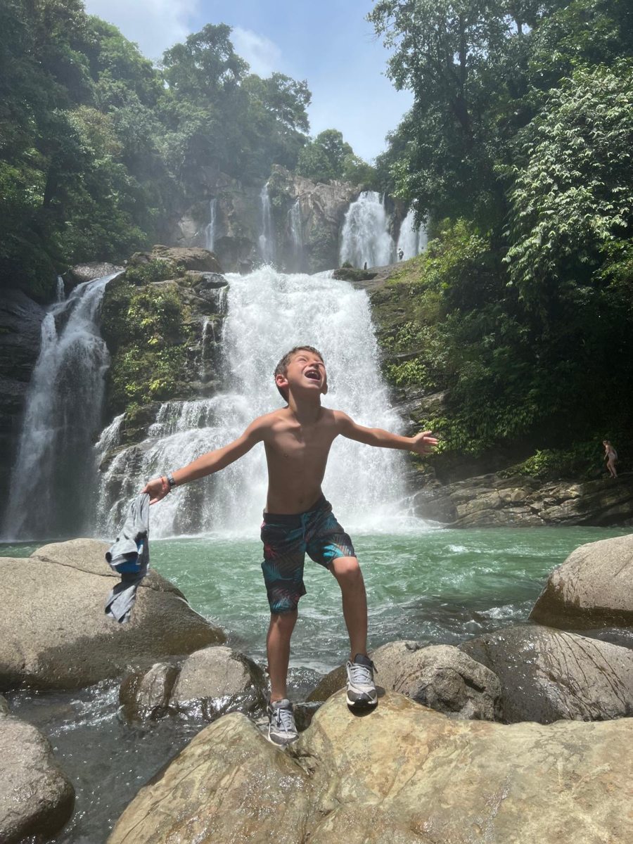 A traveler enjoying a waterfall