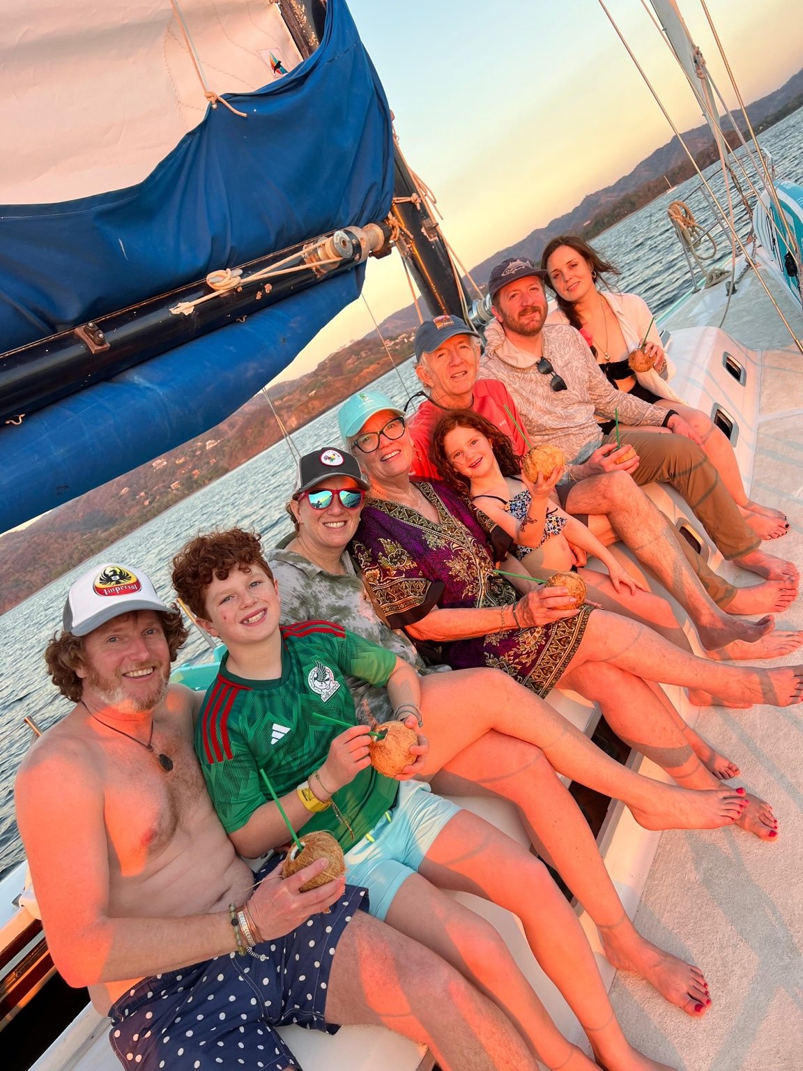 Family and friends relaxing together on a sailboat